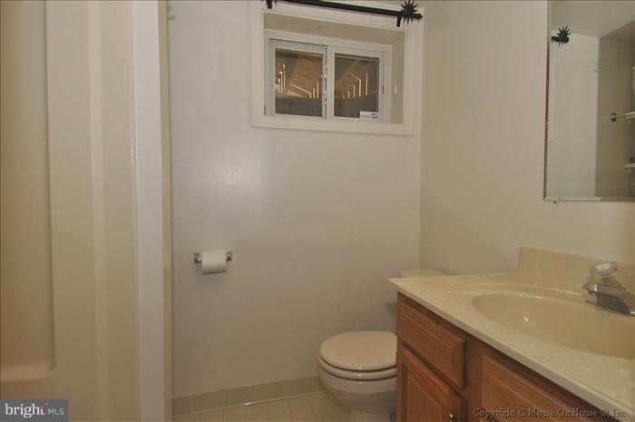 1807 Myrtle Road Silver Spring, MD 20902 - Photo 27 of 27 a bathroom with a granite countertop sink toilet and a mirror