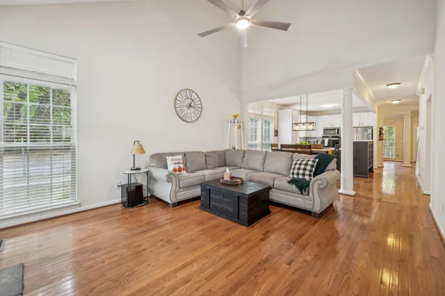 a living room with furniture and a wooden floor
