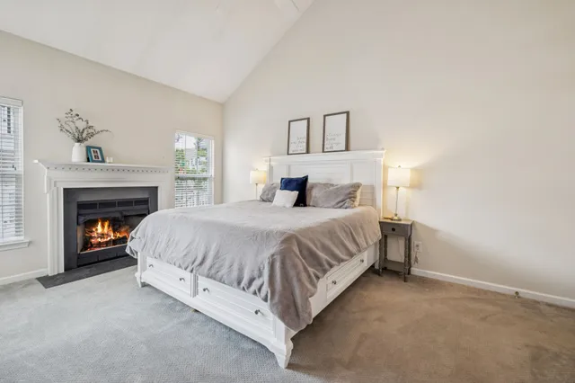 a spacious bedroom with a bed and a fireplace
