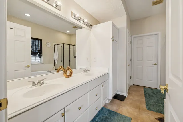 a en suite bathroom with double sink and a mirror