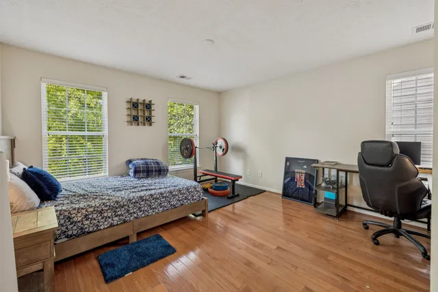 a bedroom with a bed and a large window