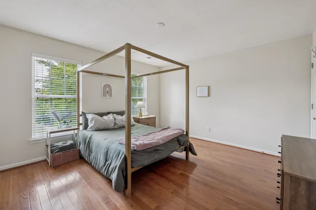 a bedroom with a bed lamp and a window