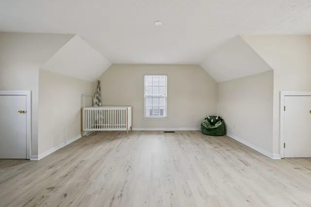 a view of a kitchen with furniture and wooden floor