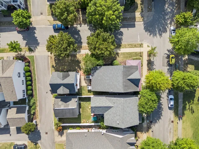 an aerial view of residential houses with outdoor space