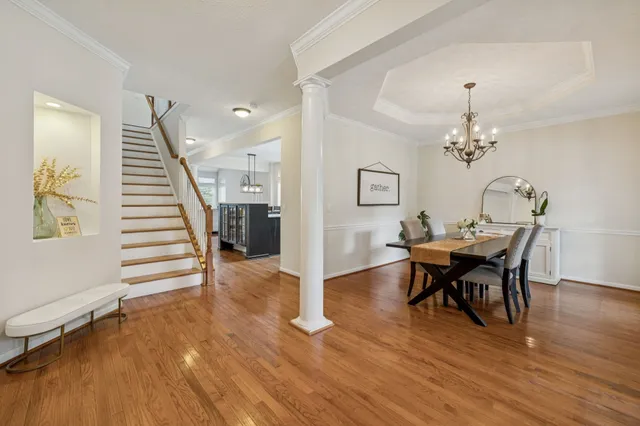 a view of a dining room with furniture and wooden floor