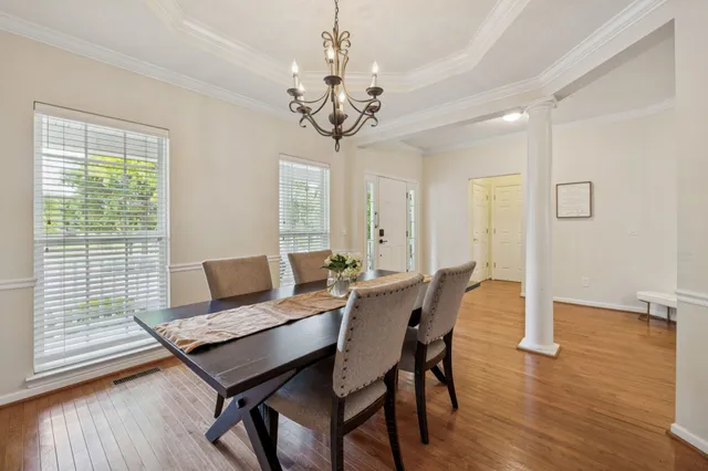a view of a dining room with furniture window and wooden floor