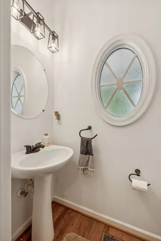 a bathroom with a sink a mirror and a toilet
