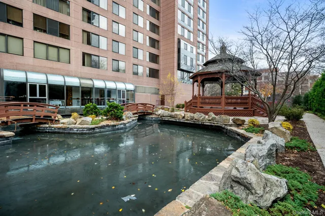 a view of swimming pool with chairs and tables in the patio