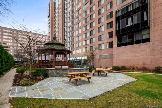 a view of a patio with a table and chairs