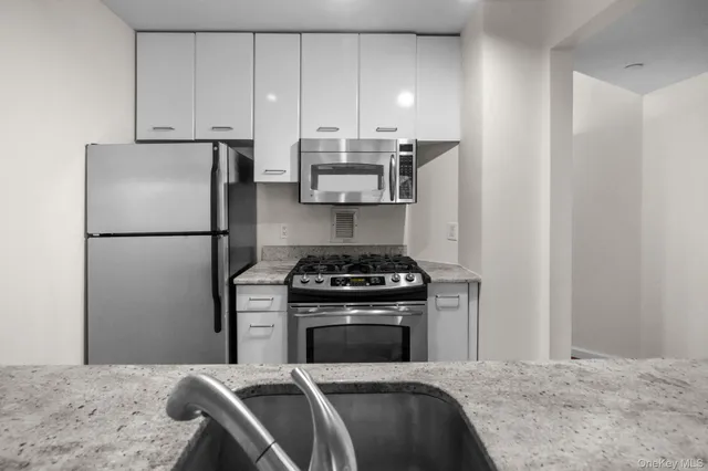 a kitchen with a stove and a refrigerator