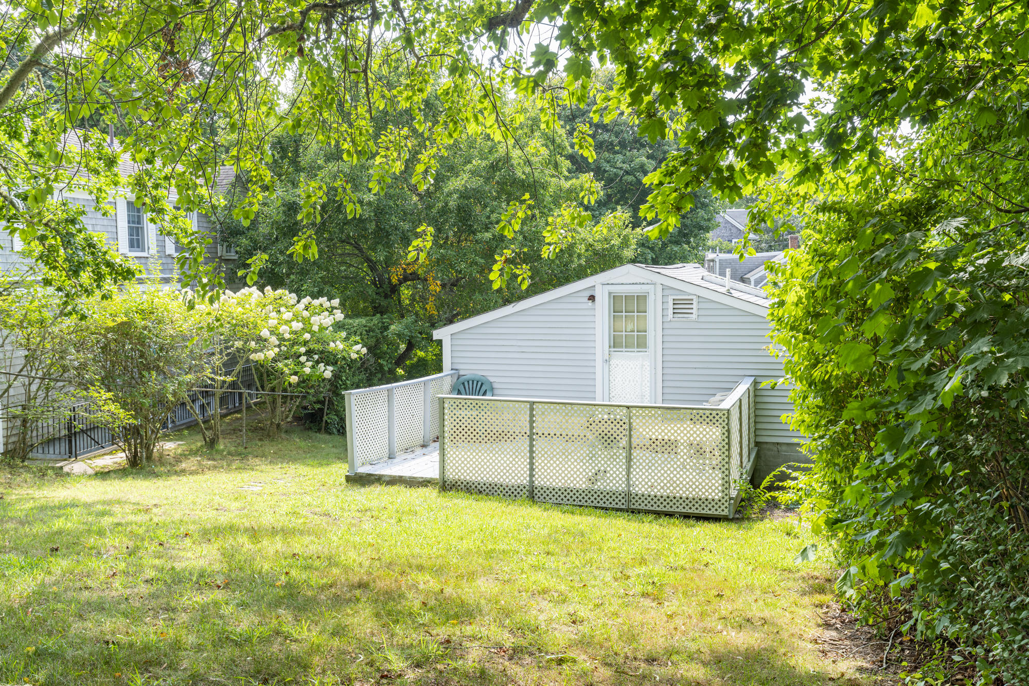 77 Queen Anne Road Chatham, MA 02633 - Photo 12 of 28 a backyard of a house with yard and tree s