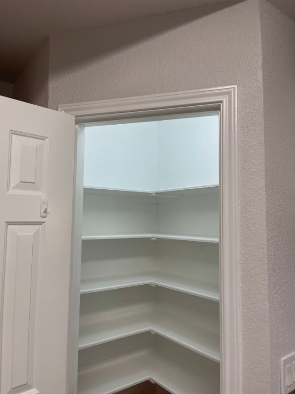 5001 Blue Bluff Road Austin, TX 78724 - Photo 14 of 28 a view of walk in closet with empty racks