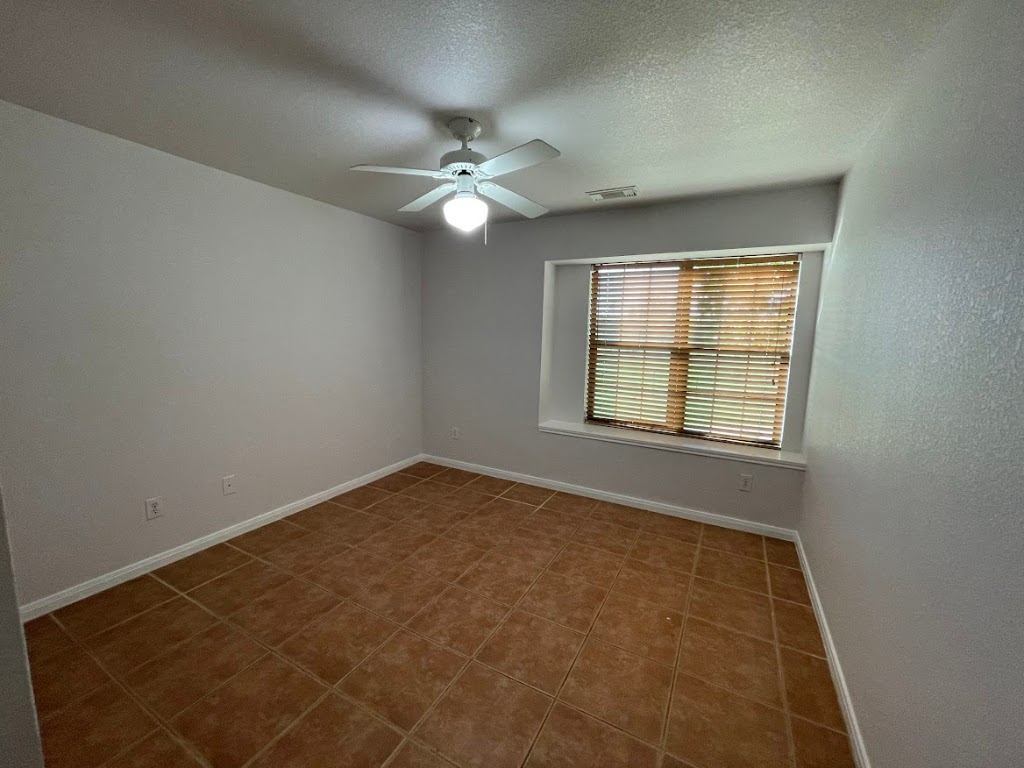 5001 Blue Bluff Road Austin, TX 78724 - Photo 23 of 28 an empty room with windows and fan