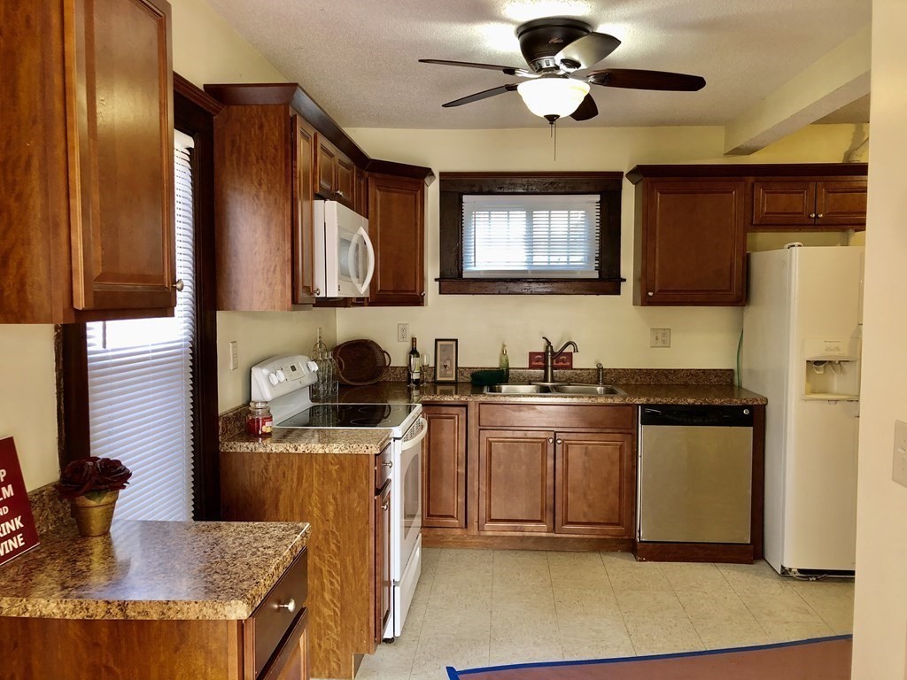 16 Sullivan Street Springfield, MA 01104 - Photo 3 of 25 a kitchen with stainless steel appliances granite countertop a stove a sink dishwasher and a refrigerator