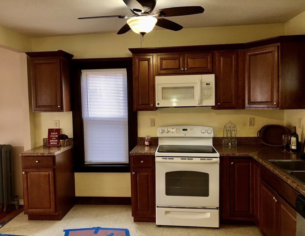 16 Sullivan Street Springfield, MA 01104 - Photo 4 of 25 a kitchen with a stove cabinets and microwave