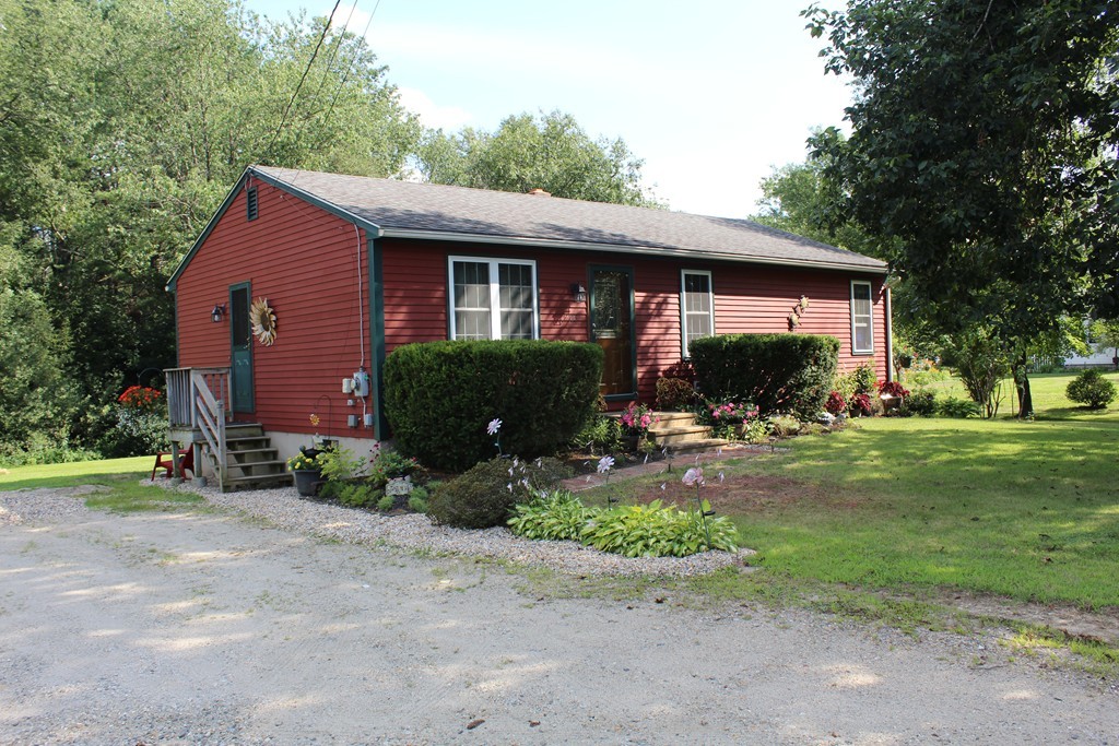 713 Wheelwright Road Barre, MA 01005 - Photo 1 of 18 a front view of house with yard and green space