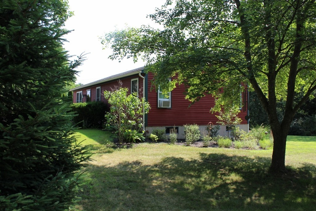 713 Wheelwright Road Barre, MA 01005 - Photo 3 of 18 a view of a backyard with plants and large trees