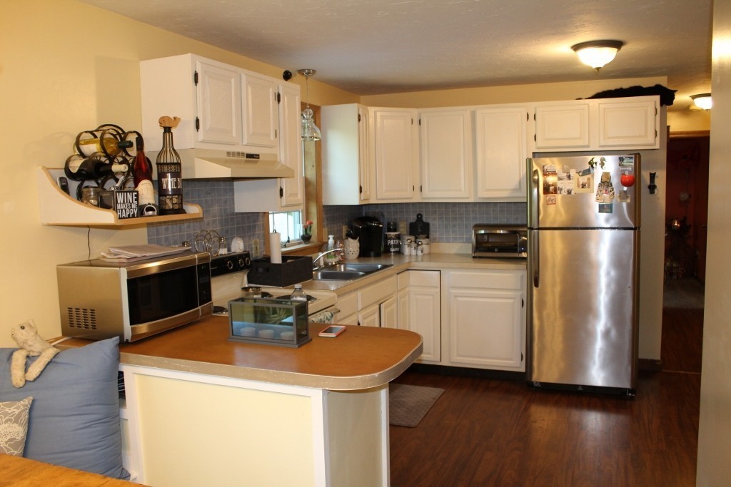 713 Wheelwright Road Barre, MA 01005 - Photo 9 of 18 a kitchen with a sink a stove and refrigerator