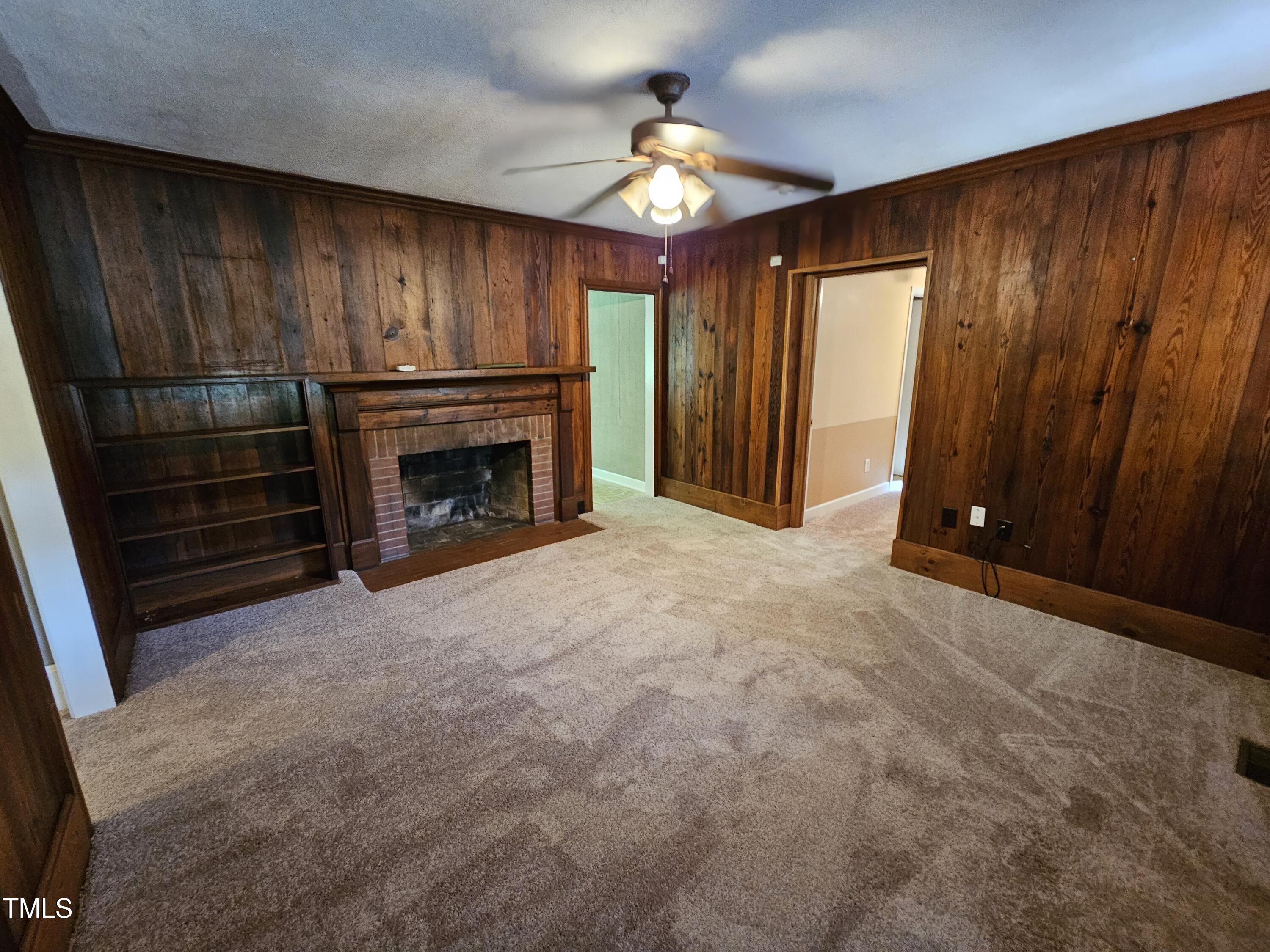 8178 Highway 751 Durham, NC 27713 - Photo 14 of 20 a view of an empty room with fireplace and a window