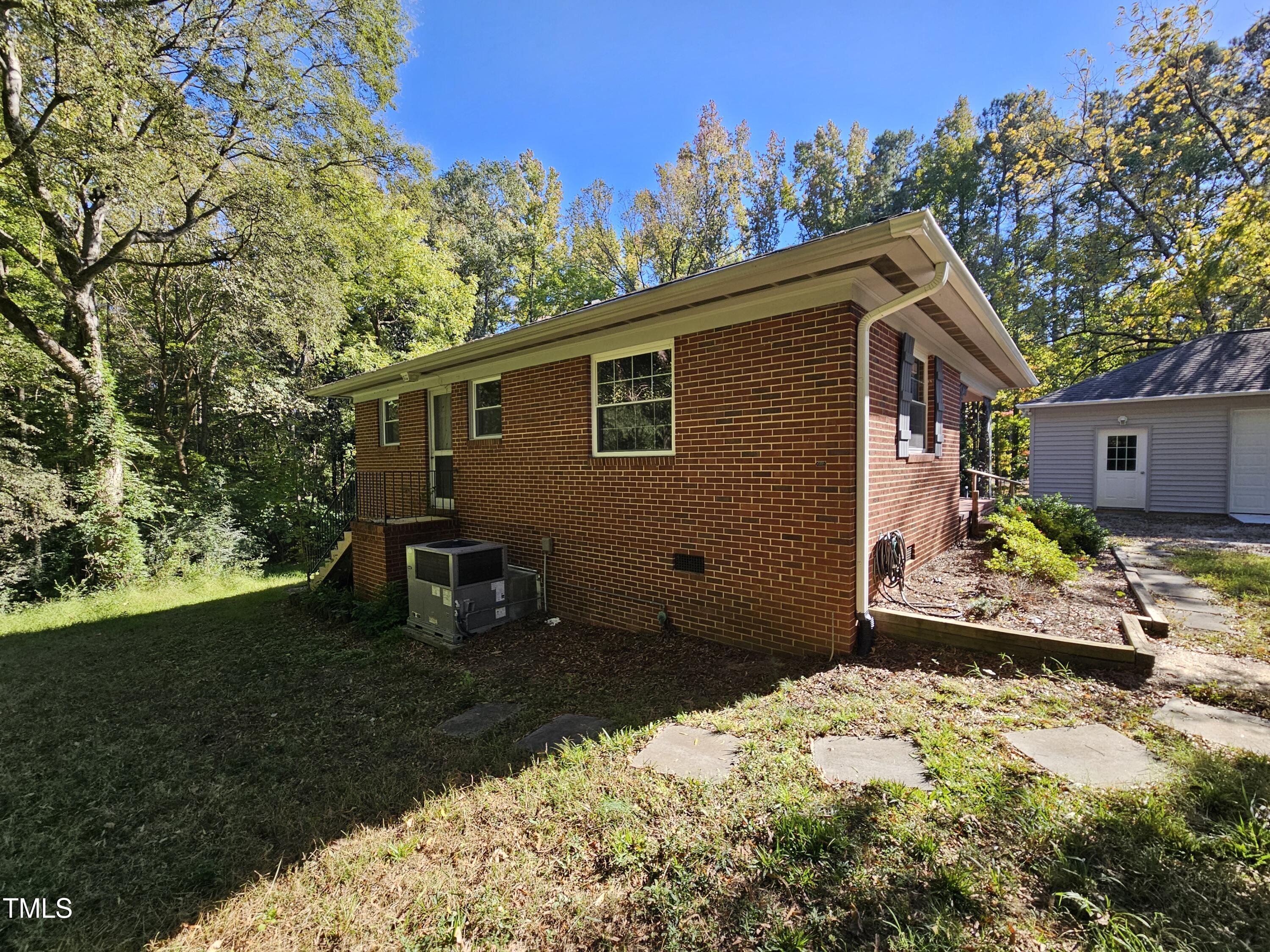 8178 Highway 751 Durham, NC 27713 - Photo 5 of 20 a backyard of a house with table and chairs