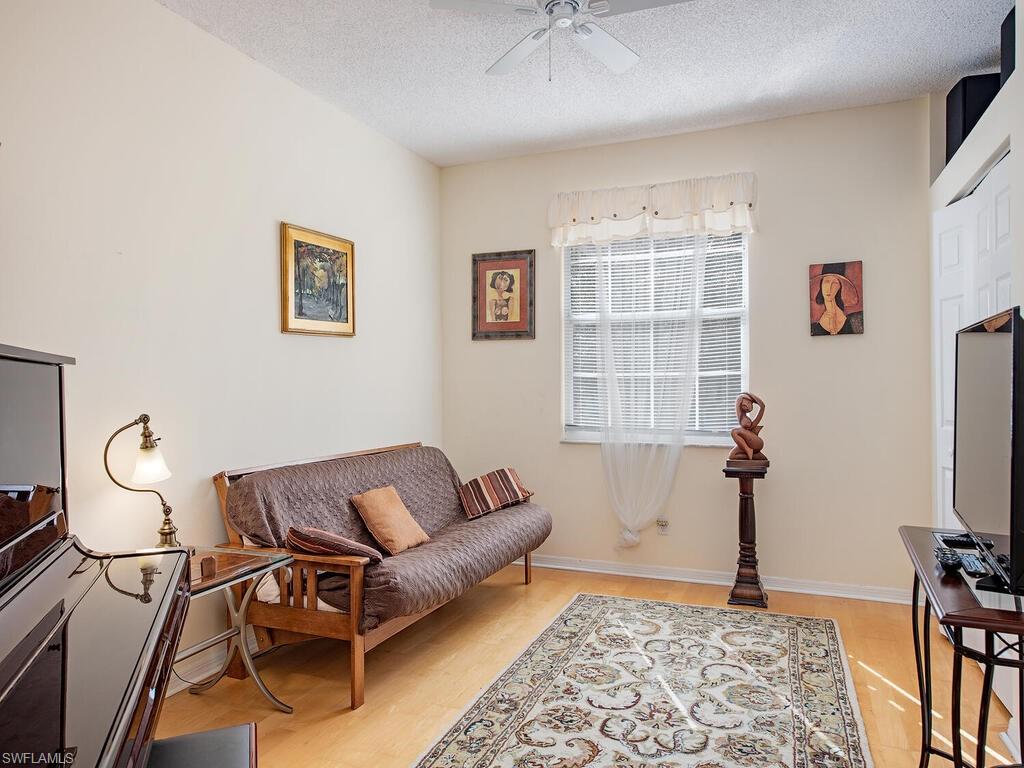 65 Silver Oaks Circle, Unit 11202 Naples, FL 34119 - Photo 9 of 12 a living room with furniture