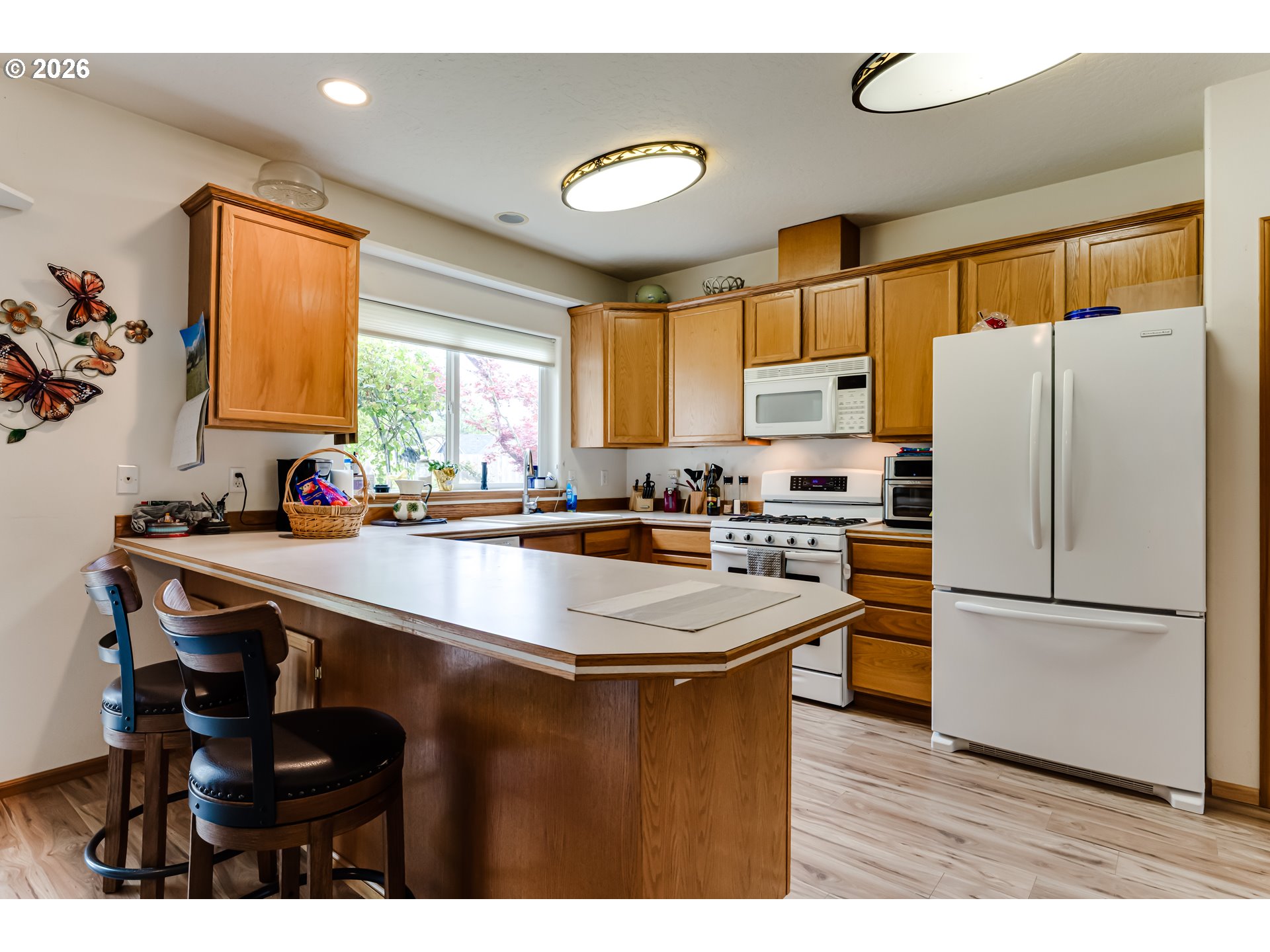 3513 Kendra Street Eugene, OR 97404 - Photo 17 of 45 a kitchen with stainless steel appliances granite countertop a refrigerator a sink a stove and a refrigerator
