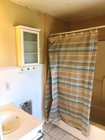 a bathroom with a bathtub and shower