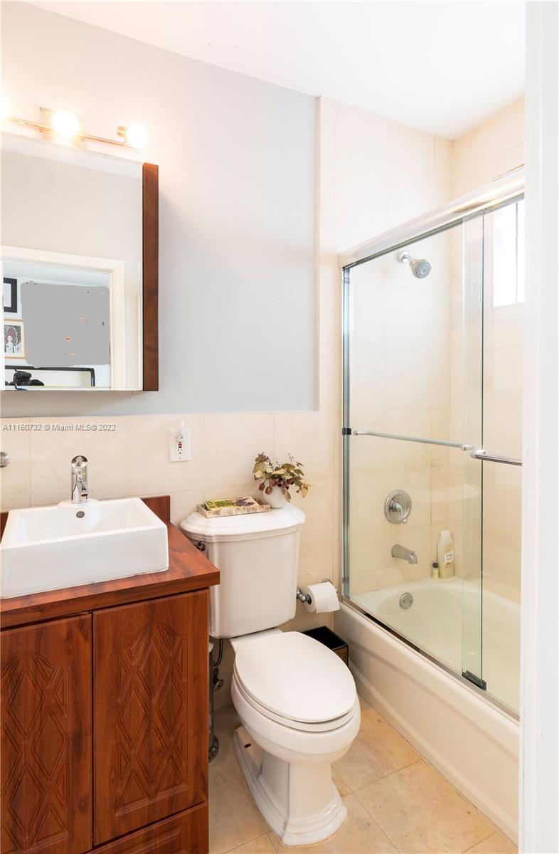 4216 Alton Road Miami Beach, FL 33140 - Photo 16 of 27 a bathroom with a sink toilet and shower