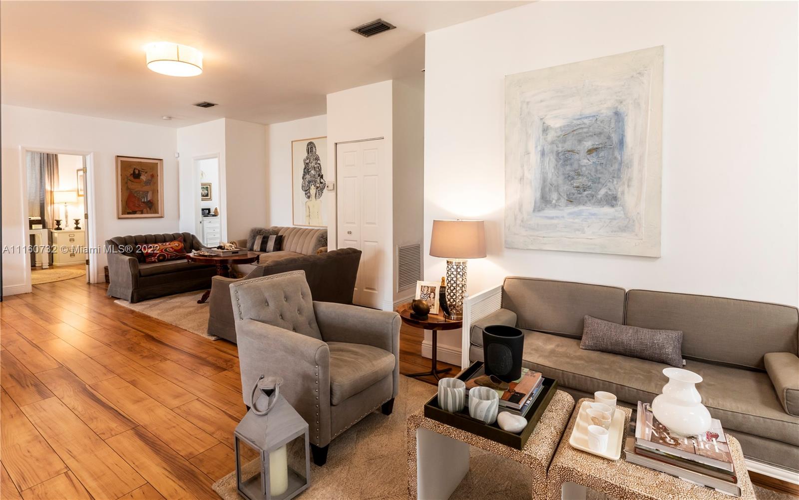 4216 Alton Road Miami Beach, FL 33140 - Photo 17 of 27 a living room with furniture wooden floor and a large window