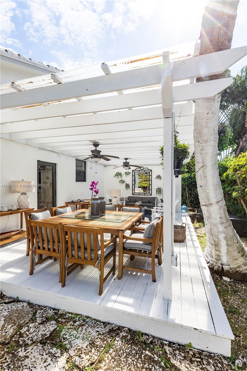 4216 Alton Road Miami Beach, FL 33140 - Photo 20 of 27 a living room with furniture pool table and potted plants