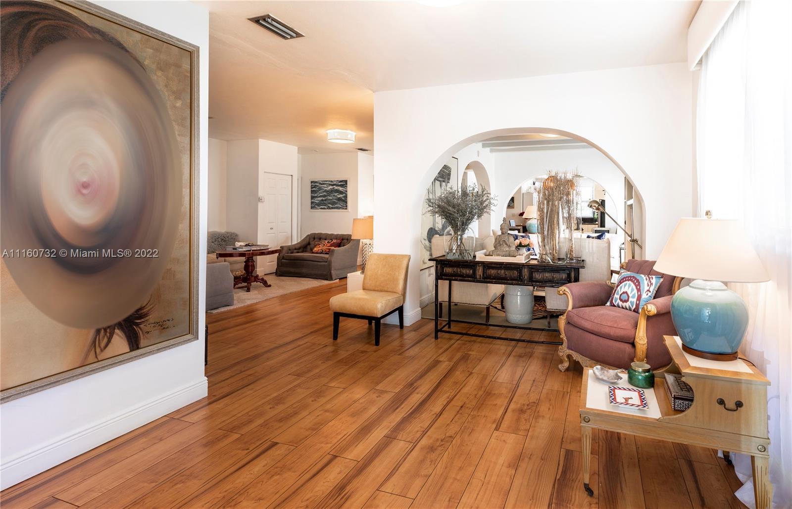 4216 Alton Road Miami Beach, FL 33140 - Photo 2 of 27 a living room with furniture and a mirror