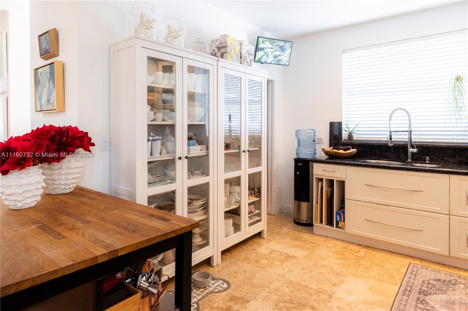 4216 Alton Road Miami Beach, FL 33140 - Photo 8 of 27 a kitchen with a sink and cabinets