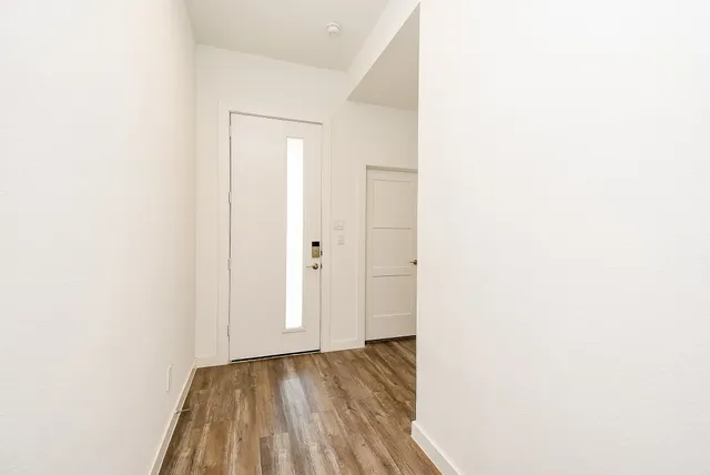 a view of a room with wooden floor