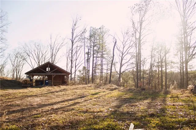 a front view of a house with a yard covered with snow and trees