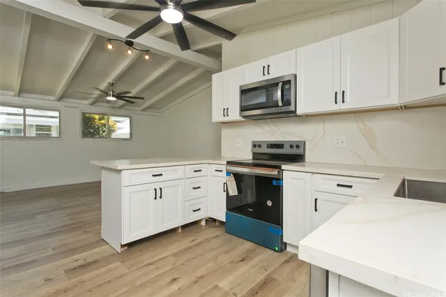 a kitchen with stainless steel appliances white cabinets and a sink