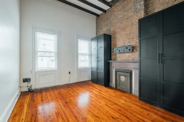 a bedroom with a bed and a fireplace