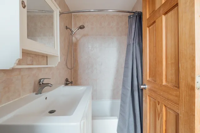 a bathroom with a shower and a sink