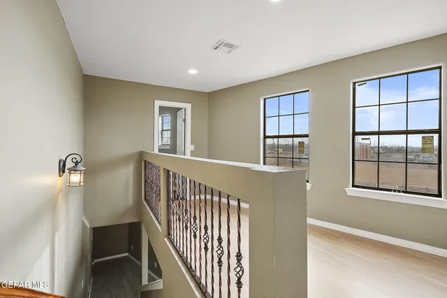 a view of a hallway with windows