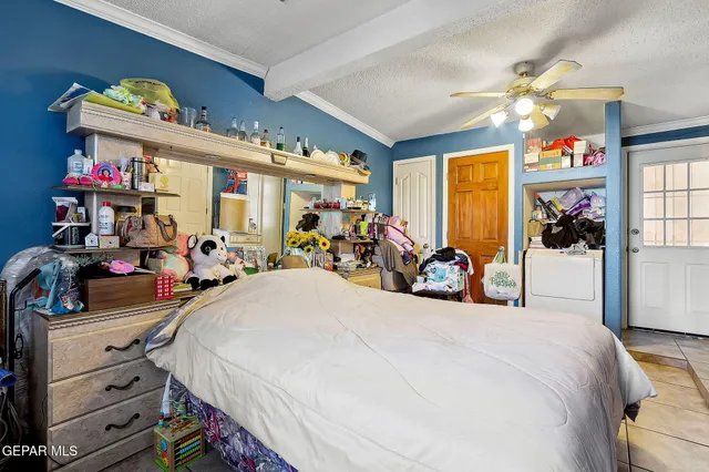 a bedroom with a bed and a flat tv screen on the wall