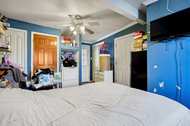 a bedroom with a bed and a dresser