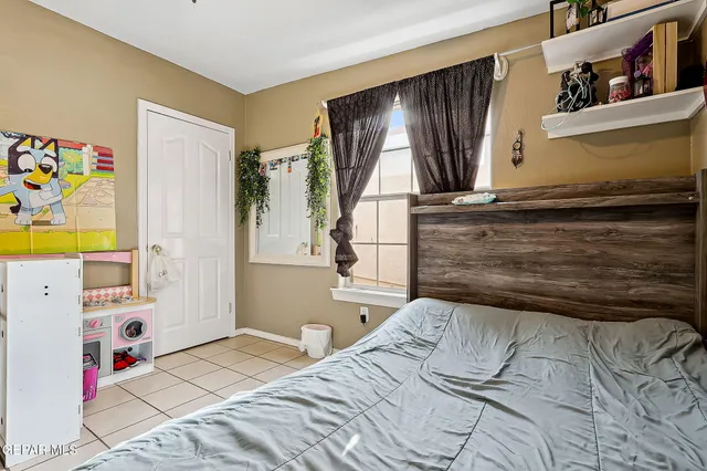 a bed room with a bed and a television