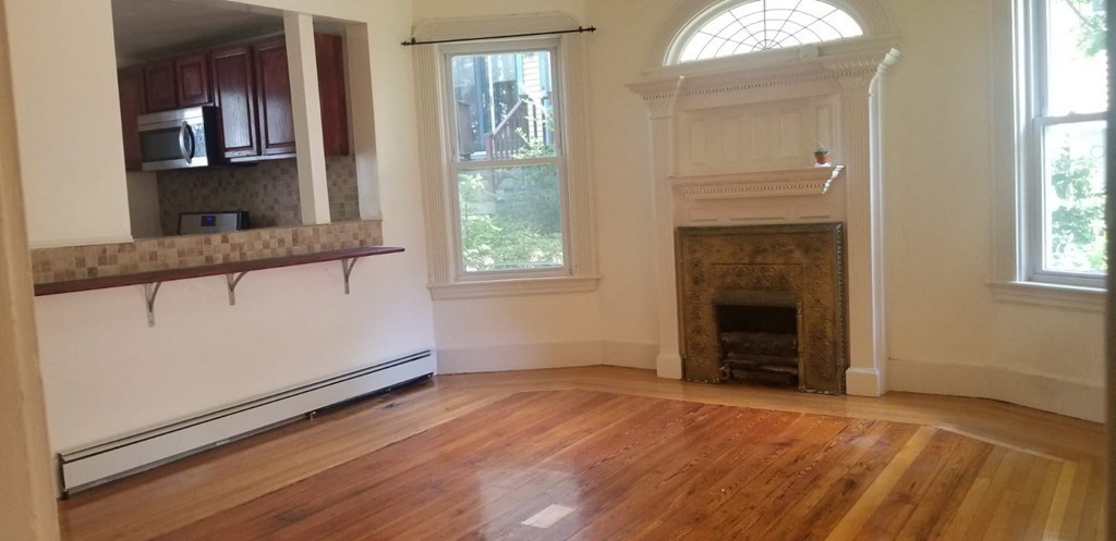 36 Gordon Street Boston, MA 02134 - Photo 1 of 14 an empty room with windows and a fireplace