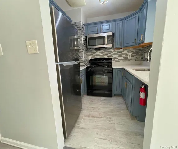 a kitchen with a refrigerator stove and microwave