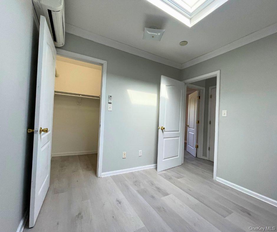 1467 Saint Marks Avenue, Unit 6 Brooklyn, NY 11233 - Photo 7 of 8 wooden floor in an empty room with a window
