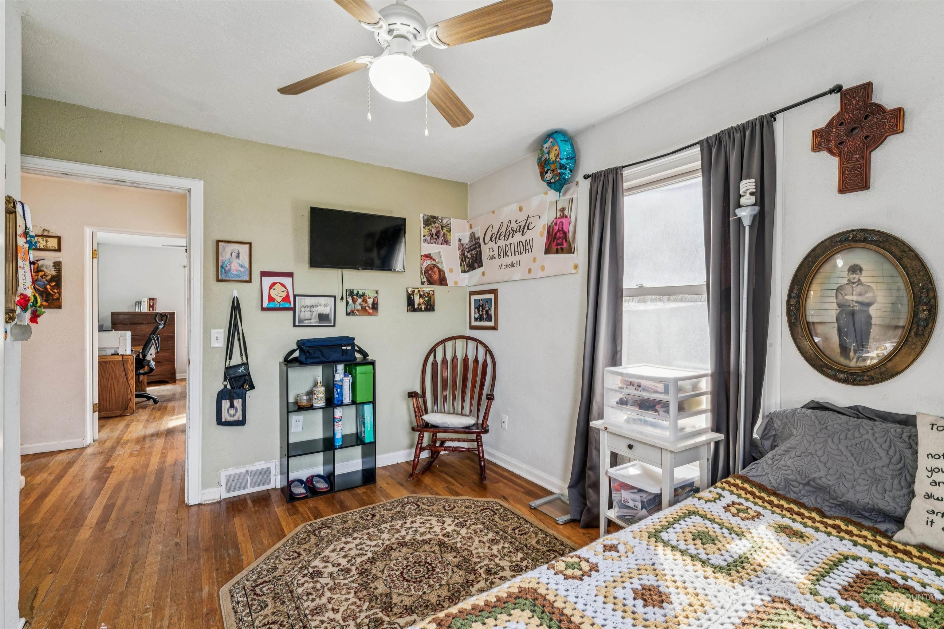 124 Halstead Street Caldwell, ID 83605 - Photo 12 of 42 Bedroom featuring dark wood-style flooring, ceiling fan, and an office area