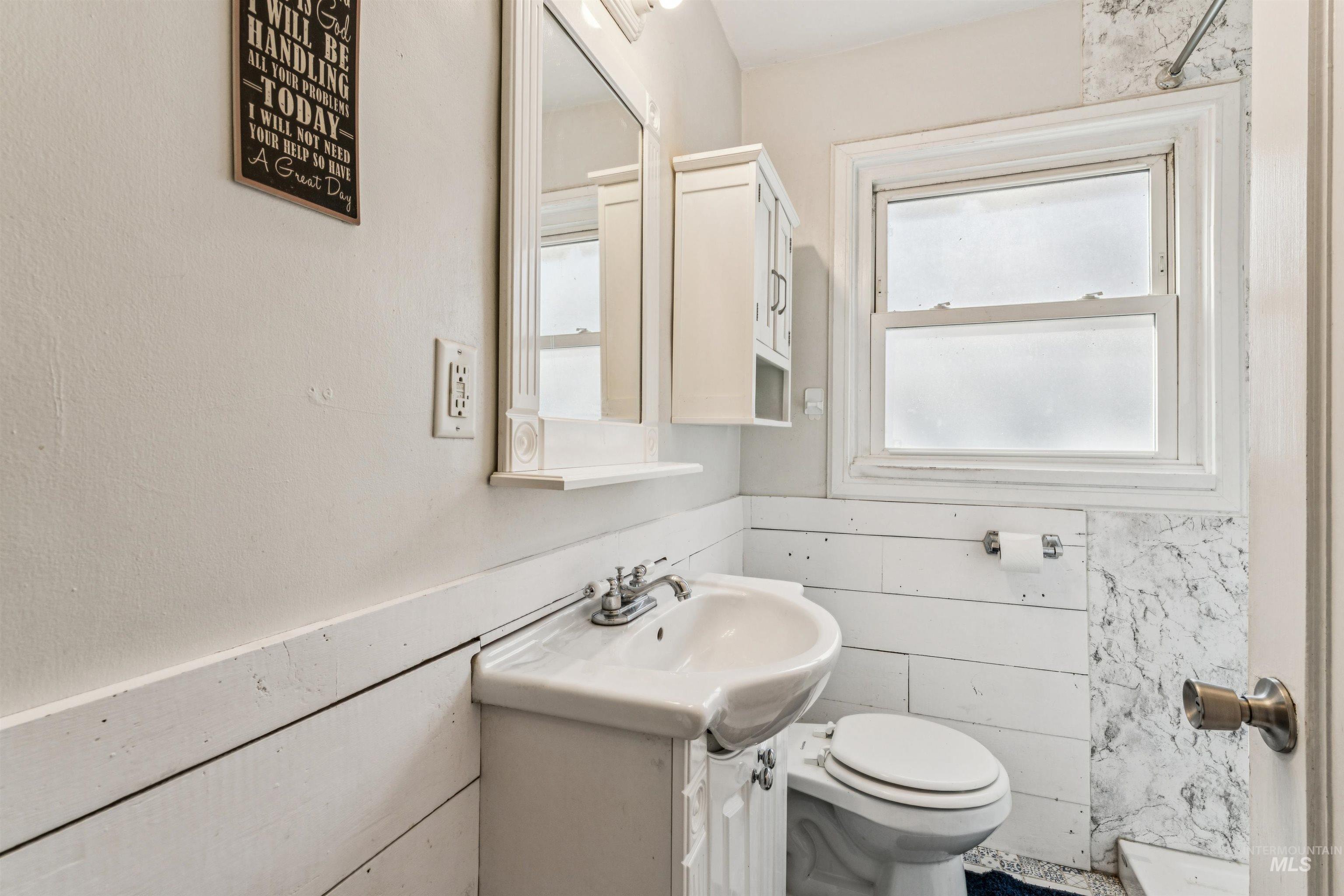 124 Halstead Street Caldwell, ID 83605 - Photo 14 of 42 Bathroom with vanity and wainscoting