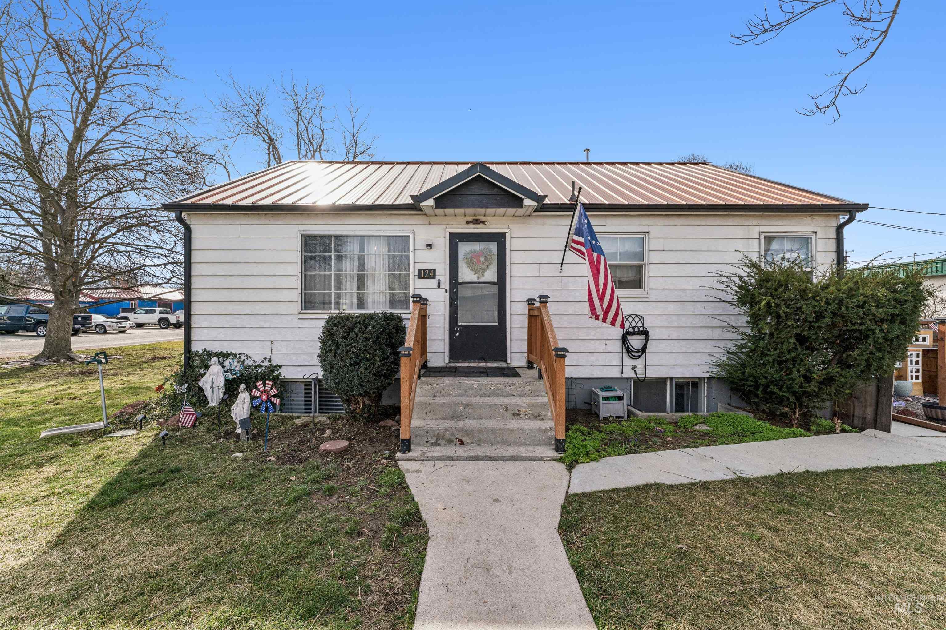 124 Halstead Street Caldwell, ID 83605 - Photo 2 of 42 Bungalow-style home featuring a front yard and a metal roof