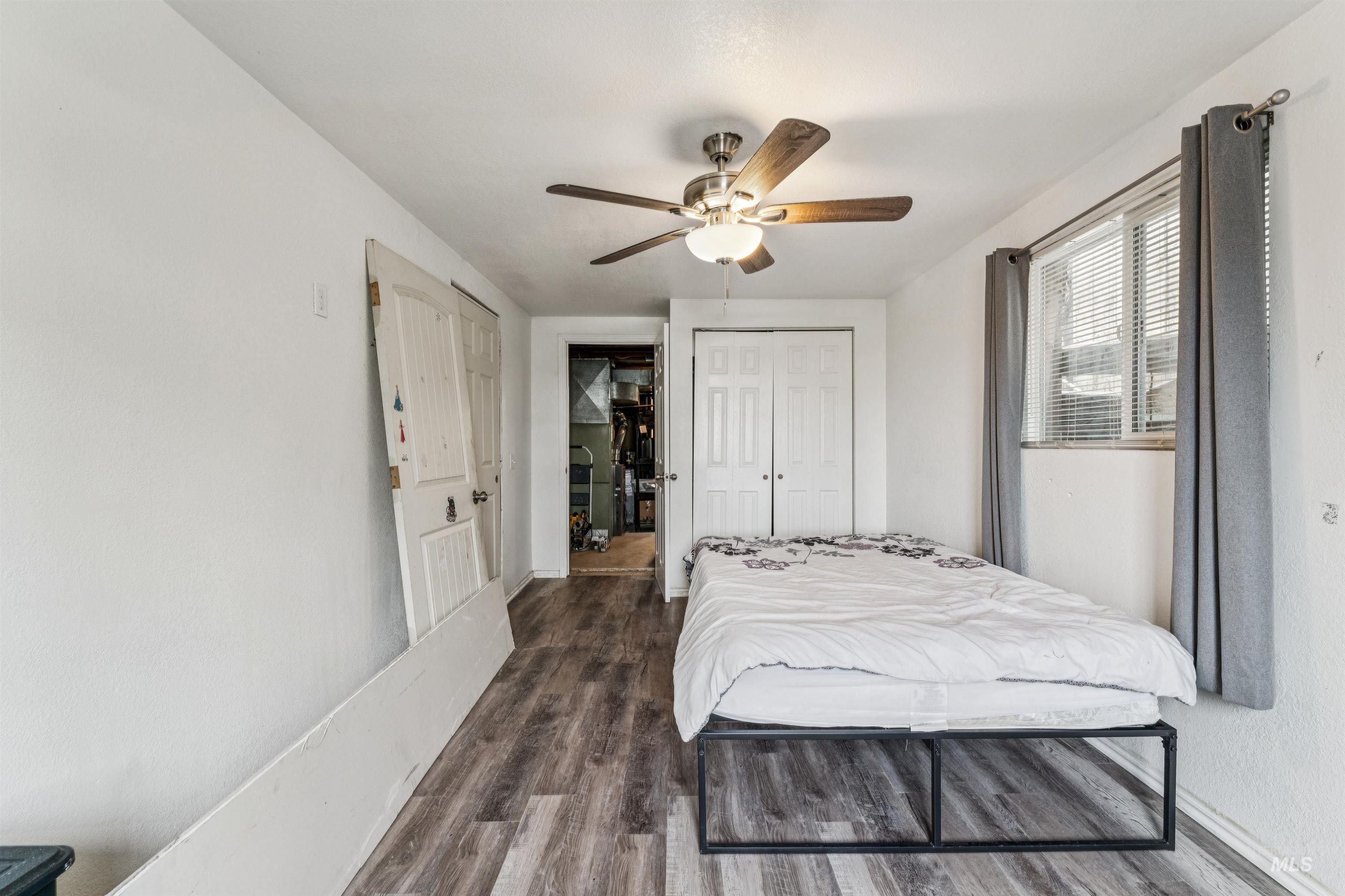 124 Halstead Street Caldwell, ID 83605 - Photo 34 of 42 Bedroom featuring dark wood-style floors, a closet, and a ceiling fan