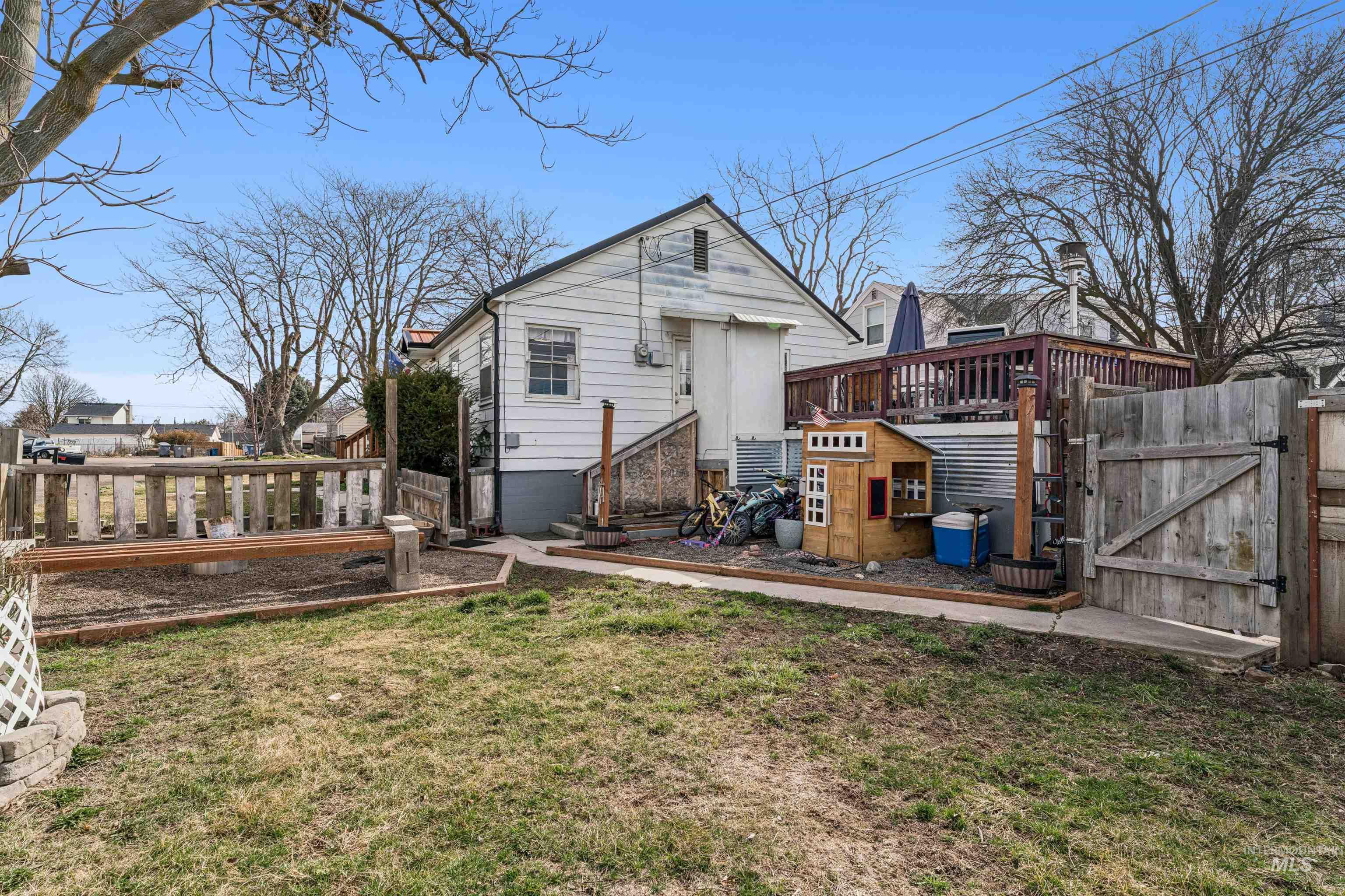 124 Halstead Street Caldwell, ID 83605 - Photo 40 of 42 Rear view of house with a gate and a deck
