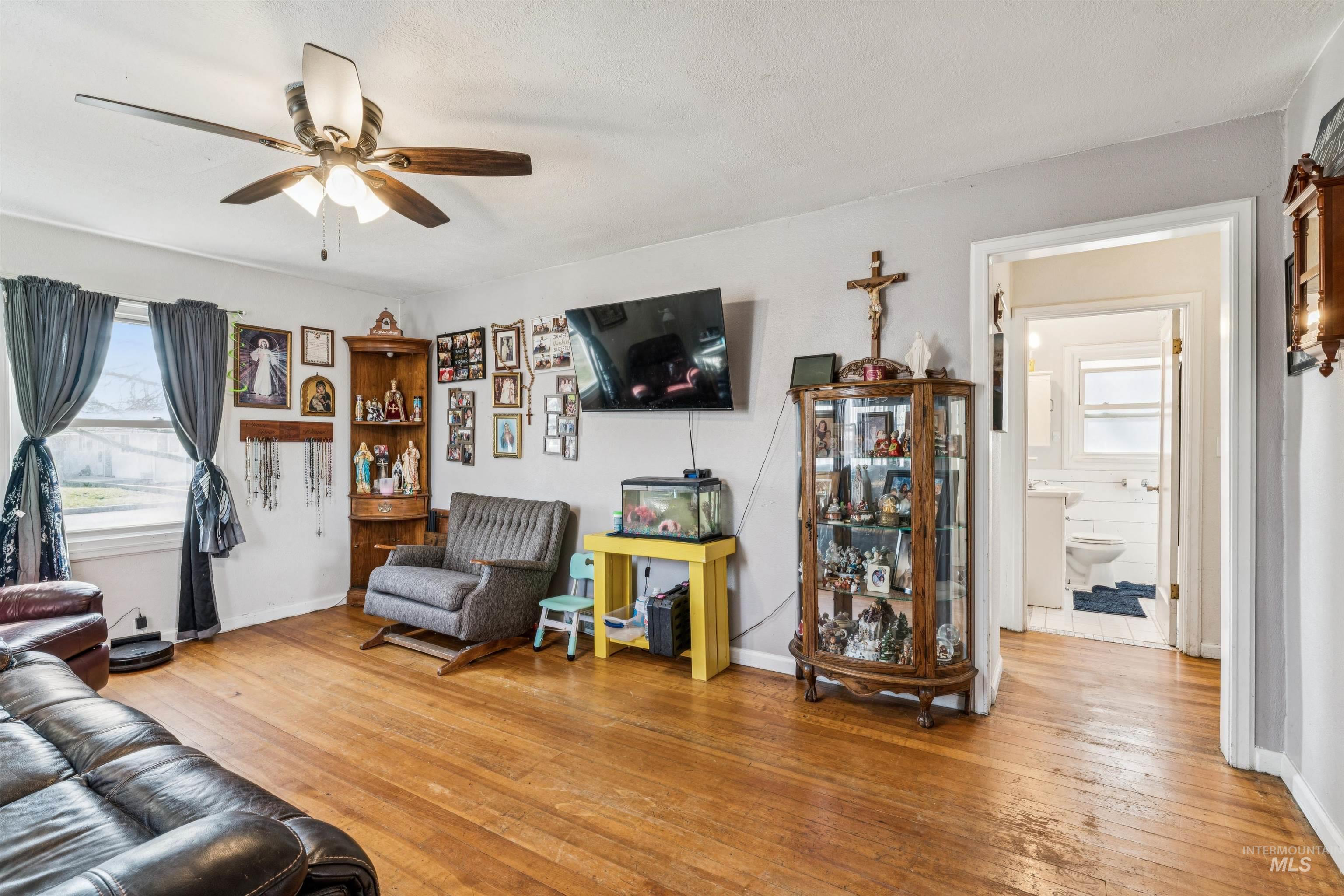 124 Halstead Street Caldwell, ID 83605 - Photo 7 of 42 Living room with light wood-style flooring and ceiling fan